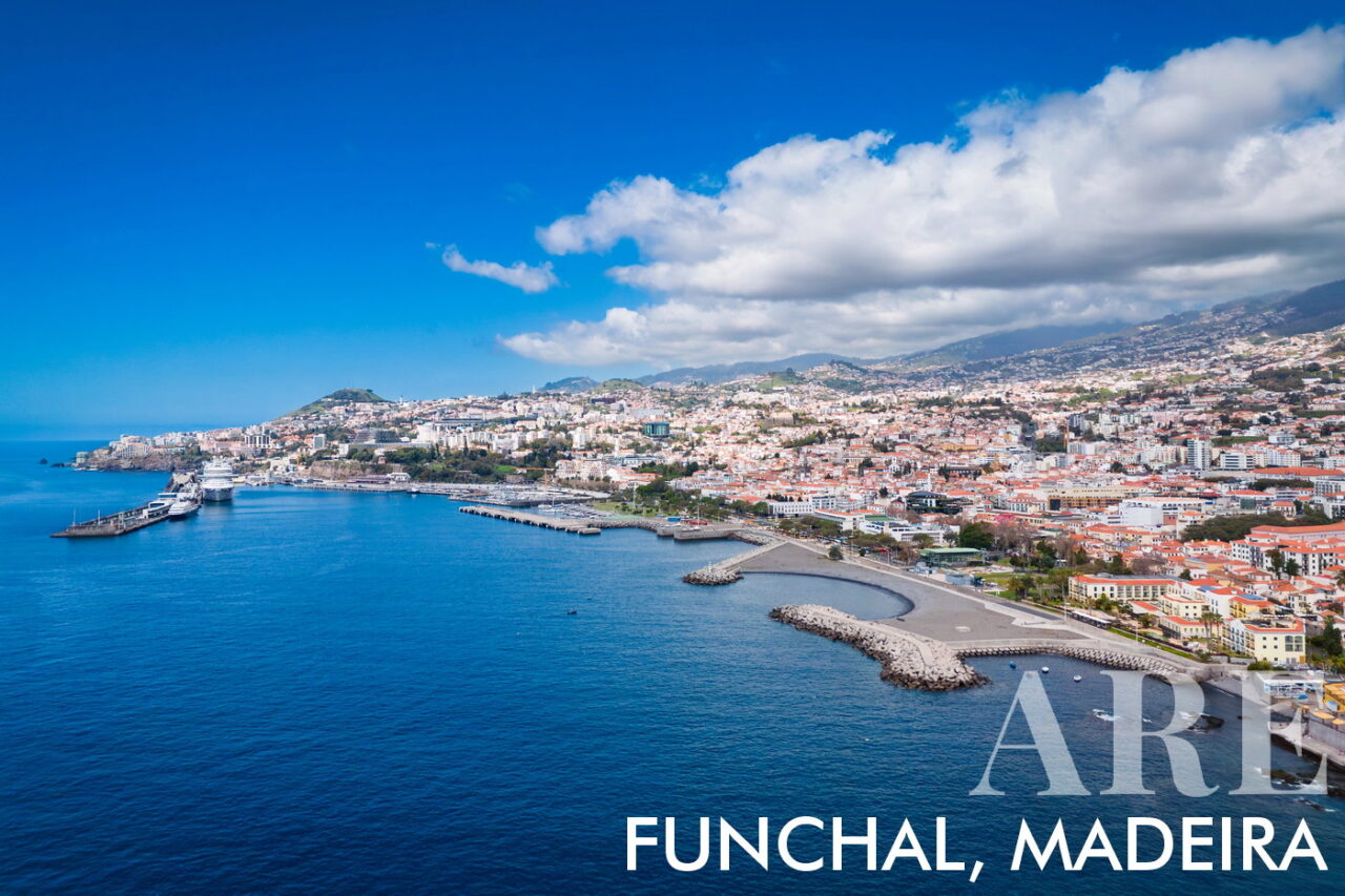 Aerial view of Funchal, capital city of Madeira showcasing the promenade, the marina, the cruising dock, and the city center. The island has approximately 250,000 inhabitants, with around 110,000 living in Funchal.