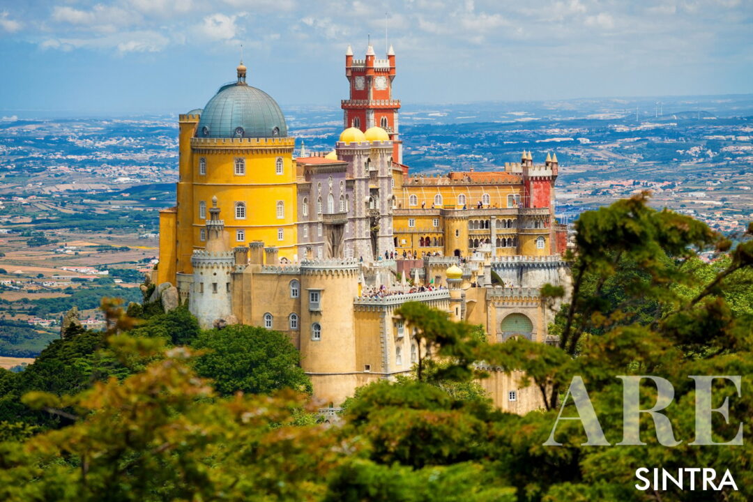 <em>Pena Palace is Sintra's most iconic landmarks and a top attraction for visitors.</em>Pena Palace, perched atop a hill in the Sintra mountains, is a vibrant and Romanticist castle renowned for its striking architectural features, characterized by its vivid colors of red, yellow, and blue.