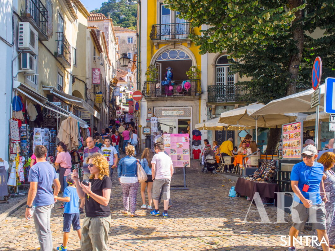 <em>Sintra's town center features cobblestone pathways and quaint, pastel-lined streets.</em>